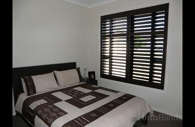 Bedromm setting with dark walnut stained Timber Plantation Shutters Melbourne