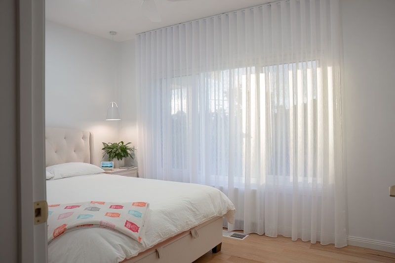 White Sheer Curtains S-Fold mounted on motorised track, ceiling to floor installation in a bedroom setting in Melbourne