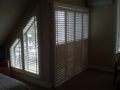 Triangle shaped plantation shutters mounted on insde fit on side window
